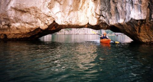 The calm waters of Halong Bay are a great place to kayak and explore floating villages and hidden lagoons! Womens travel spcialists ©Venus Adventures