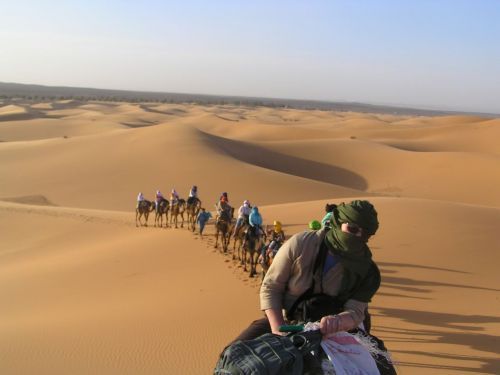 Riding camels into the Saharan sunset - great travel for solos ©Venus Adventures
